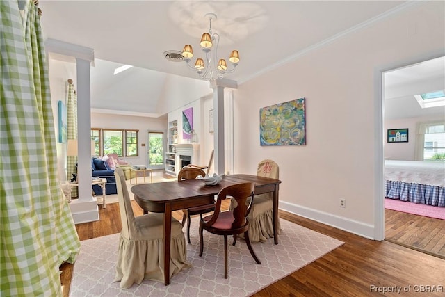20 Winstead Dr, Irvington, VA 22480 - dining room with wood finished floors, baseboards, healthy amount of natural light, crown molding, and a chandelier