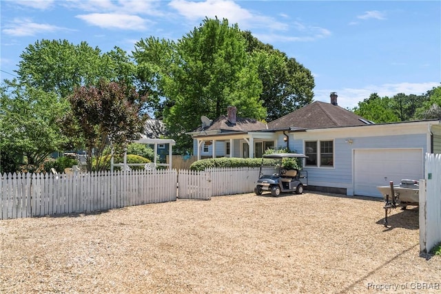 20 Winstead Dr, Irvington, VA 22480 - rear view of house with an attached garage, a fenced front yard, driveway, and a gate