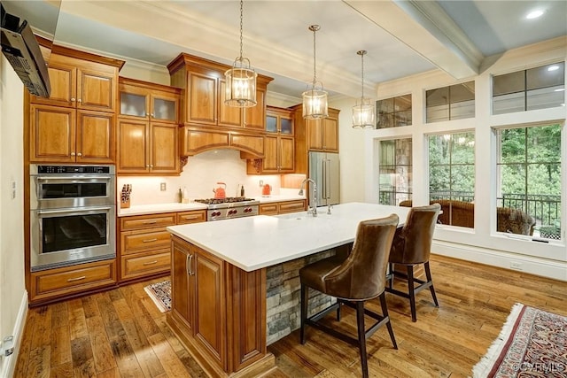 717 Old Stream Rd, Manakin Sabot, VA 23103 - kitchen with brown cabinets, appliances with stainless steel finishes, light countertops, crown molding, and beamed ceiling