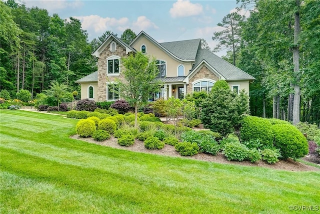 717 Old Stream Rd, Manakin Sabot, VA 23103 - view of front of home with stone siding, a front lawn, a standing seam roof, and stucco siding