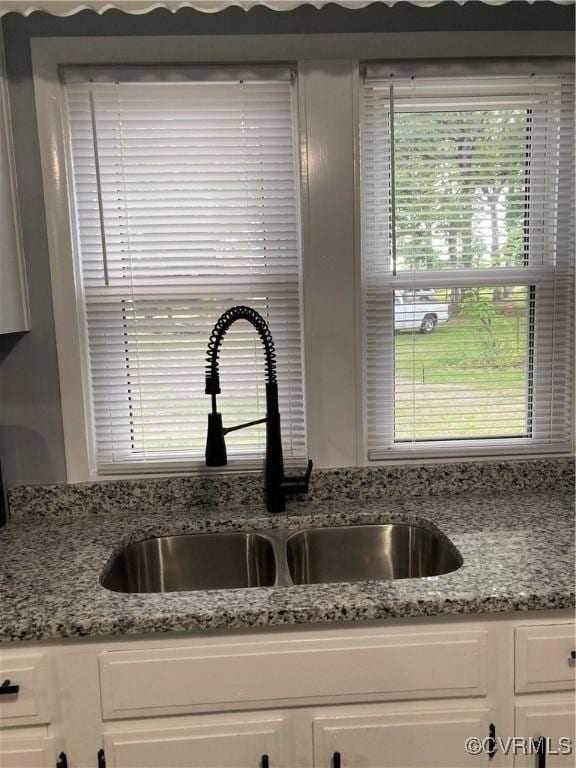 2517 Myron Ave, Chesterfield, VA 23237 - kitchen view of a sink, white cabinetry, and light stone counters