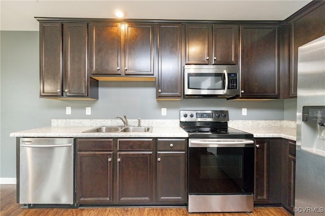 3316 New Heritage Loop, Henrico, VA 23231 - kitchen with stainless steel appliances, a sink, dark brown cabinetry, and wood finished floors