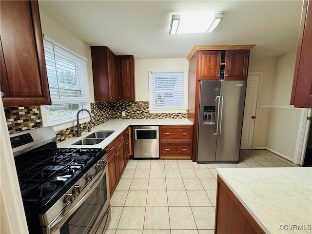 2708 Elgin Rd, Henrico, VA 23223 - kitchen featuring appliances with stainless steel finishes, a sink, tasteful backsplash, light countertops, and light tile patterned flooring