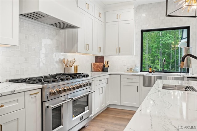 3940 Mill Station Dr, Powhatan, VA 23139 - kitchen featuring range with two ovens, custom exhaust hood, white cabinets, and tasteful backsplash