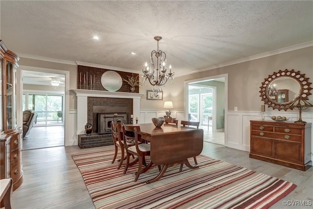 1825 Rock Point Dr, Powhatan, VA 23139 - dining area with a textured ceiling, light wood-style floors, a decorative wall, plenty of natural light, and ornamental molding