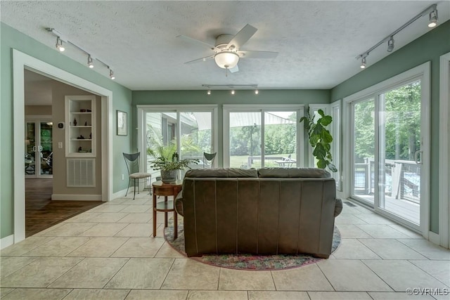 1825 Rock Point Dr, Powhatan, VA 23139 - living area featuring rail lighting, a ceiling fan, plenty of natural light, light tile patterned floors, and a textured ceiling