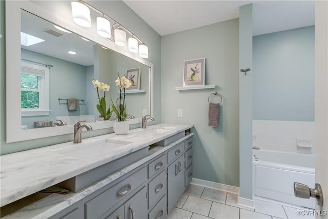 1825 Rock Point Dr, Powhatan, VA 23139 - full bathroom with double vanity, a garden tub, tile patterned floors, and baseboards