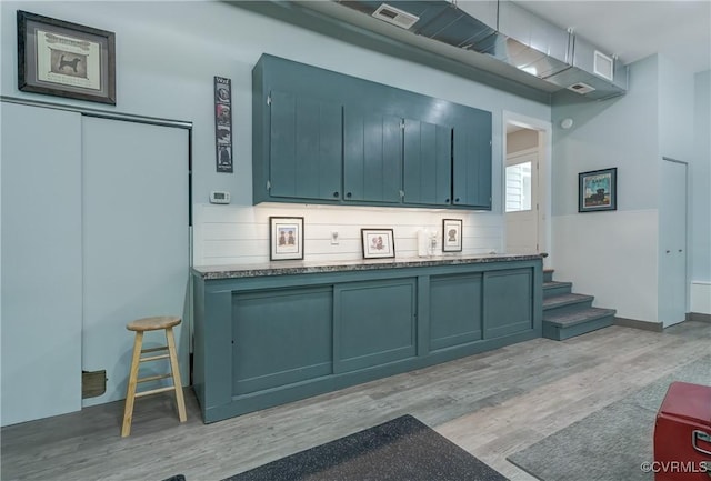 1825 Rock Point Dr, Powhatan, VA 23139 - kitchen featuring light wood finished floors, blue cabinets, and baseboards