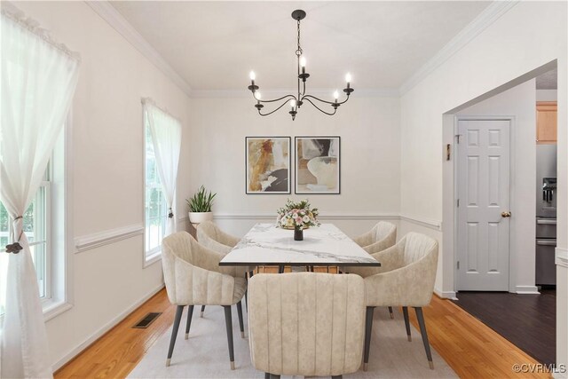 8401 Bethia Rd, Chesterfield, VA 23832 - dining room with a chandelier, light wood-style flooring, crown molding, and baseboards