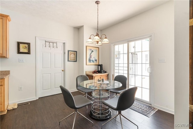 8401 Bethia Rd, Chesterfield, VA 23832 - dining room with dark wood-style flooring, healthy amount of natural light, a chandelier, and baseboards