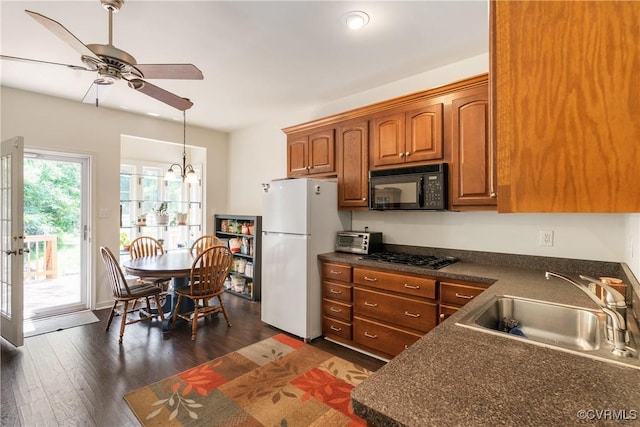8401 Bethia Rd, Chesterfield, VA 23832 - kitchen with black microwave, freestanding refrigerator, dark countertops, and gas stovetop