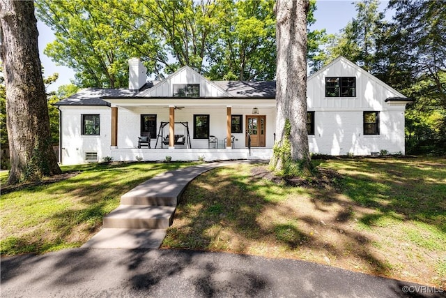 200 N Ridge Rd, Henrico, VA 23229 - modern inspired farmhouse featuring covered porch, brick siding, a chimney, and a front lawn