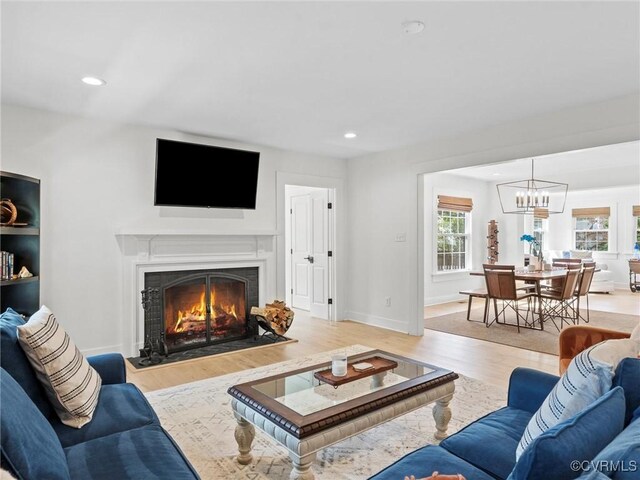 200 N Ridge Rd, Henrico, VA 23229 - living room with a chandelier, a lit fireplace, wood finished floors, recessed lighting, and baseboards