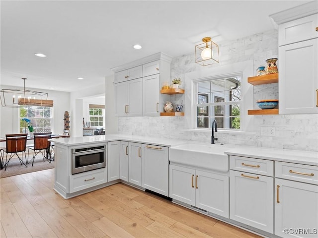 200 N Ridge Rd, Henrico, VA 23229 - kitchen with open shelves, a sink, a chandelier, light countertops, and a peninsula