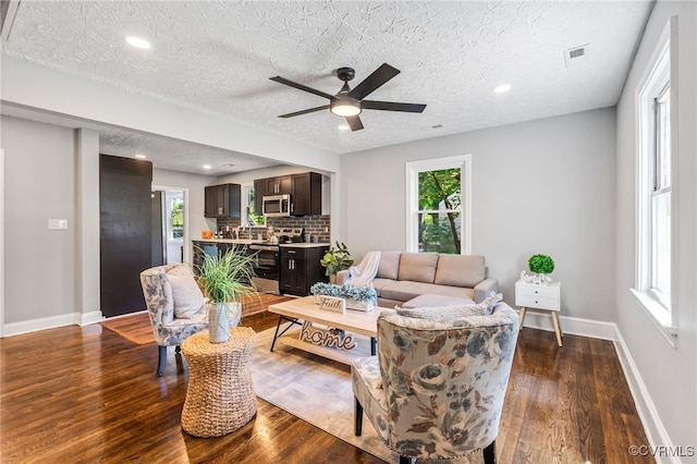 2039 Richmond Ave, Petersburg, VA 23803 - living area with dark wood finished floors, a textured ceiling, a ceiling fan, baseboards, and recessed lighting