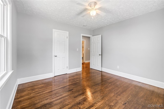 2039 Richmond Ave, Petersburg, VA 23803 - unfurnished bedroom with wood finished floors, a textured ceiling, baseboards, and a ceiling fan
