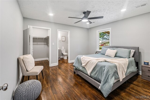 2039 Richmond Ave, Petersburg, VA 23803 - bedroom featuring wood finished floors, a walk in closet, baseboards, a ceiling fan, and connected bathroom
