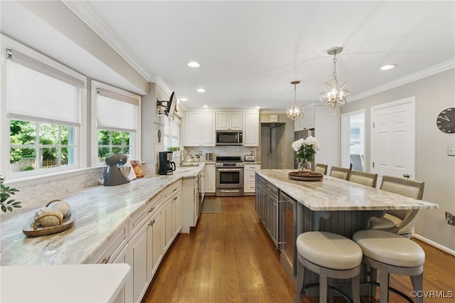 3700 Milbranch Pl, Henrico, VA 23233 - kitchen featuring appliances with stainless steel finishes, a breakfast bar area, a sink, light stone countertops, and ornamental molding