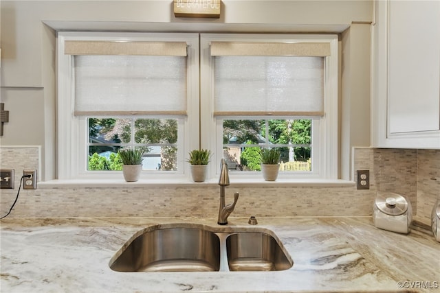 3700 Milbranch Pl, Henrico, VA 23233 - kitchen featuring a sink, decorative backsplash, light stone countertops, and white cabinetry