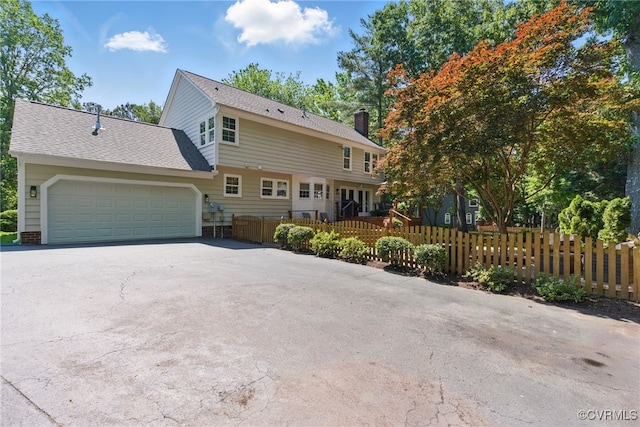 3700 Milbranch Pl, Henrico, VA 23233 - view of front of house with a garage, concrete driveway, a chimney, and roof with shingles