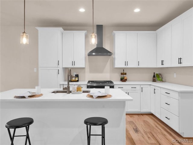 30307 Victoria Way, Petersburg, VA 23805 - kitchen featuring wall chimney exhaust hood, a kitchen breakfast bar, stainless steel stove, a sink, and hanging light fixtures