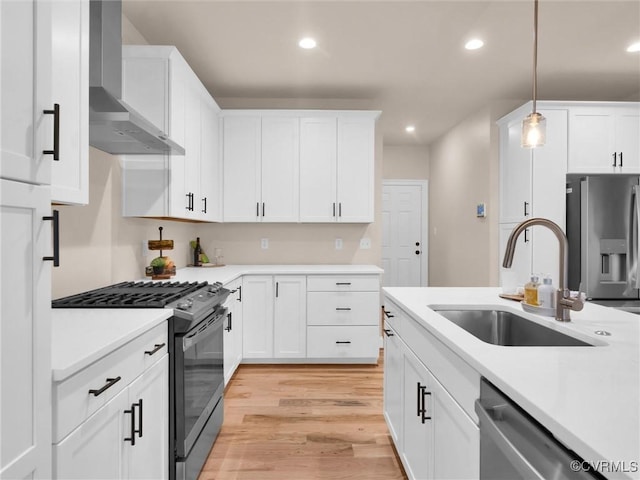 30307 Victoria Way, Petersburg, VA 23805 - kitchen featuring appliances with stainless steel finishes, wall chimney range hood, a sink, light wood-style flooring, and recessed lighting