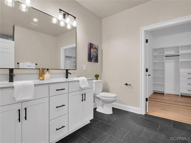 30307 Victoria Way, Petersburg, VA 23805 - bathroom featuring toilet, tile patterned floors, double vanity, baseboards, and a walk in closet
