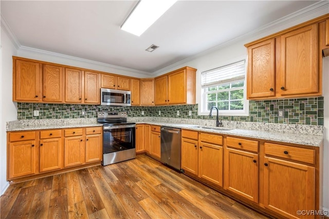 5 Walters Way, Bumpass, VA 23024 - kitchen featuring appliances with stainless steel finishes, a sink, dark wood-type flooring, tasteful backsplash, and crown molding