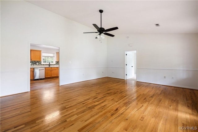 5 Walters Way, Bumpass, VA 23024 - unfurnished living room with light wood-style floors, ceiling fan, a sink, high vaulted ceiling, and baseboards