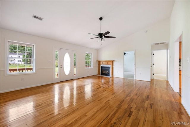 5 Walters Way, Bumpass, VA 23024 - unfurnished living room featuring ceiling fan, light wood finished floors, plenty of natural light, a fireplace with flush hearth, and high vaulted ceiling