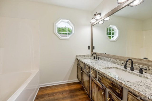 5 Walters Way, Bumpass, VA 23024 - full bath featuring hardwood / wood-style flooring, baseboards, double vanity, a bath, and a shower