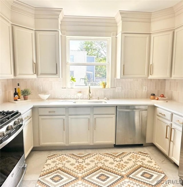 1500 N 23rd St, Richmond, VA 23223 - kitchen featuring stainless steel appliances, backsplash, light countertops, and crown molding
