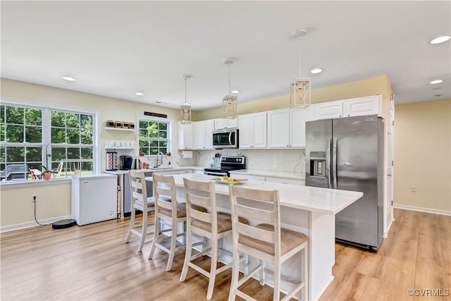 8118 Mimosa Hill Ln, Mechanicsville, VA 23116 - kitchen featuring stainless steel appliances, light wood finished floors, white cabinetry, and recessed lighting