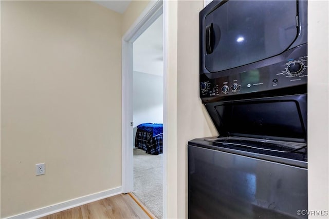 8118 Mimosa Hill Ln, Mechanicsville, VA 23116 - laundry room featuring stacked washer / dryer and wood finished floors