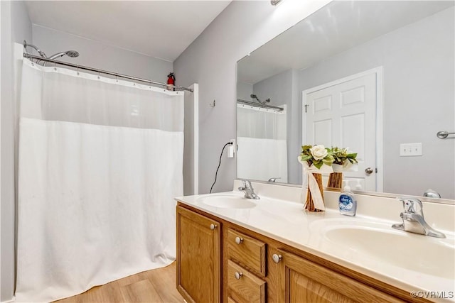 8118 Mimosa Hill Ln, Mechanicsville, VA 23116 - bathroom with double vanity, wood finished floors, and curtained shower