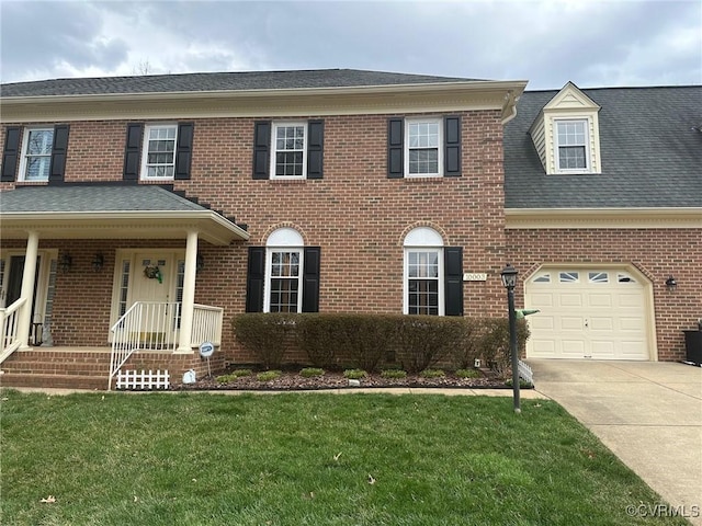 10003 Four Iron Ct, Fredericksburg, VA 22408 - colonial inspired home with concrete driveway, brick siding, and a front yard
