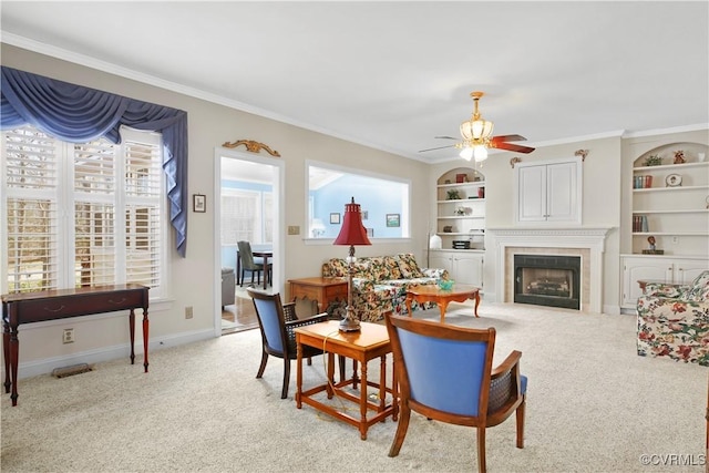 10003 Four Iron Ct, Fredericksburg, VA 22408 - living area with light carpet, ceiling fan, a tile fireplace, crown molding, and built in features