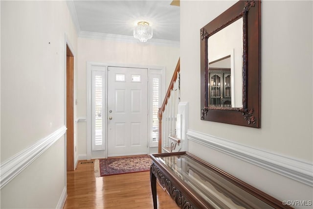 10003 Four Iron Ct, Fredericksburg, VA 22408 - foyer with light wood-style floors, ornamental molding, baseboards, and a chandelier