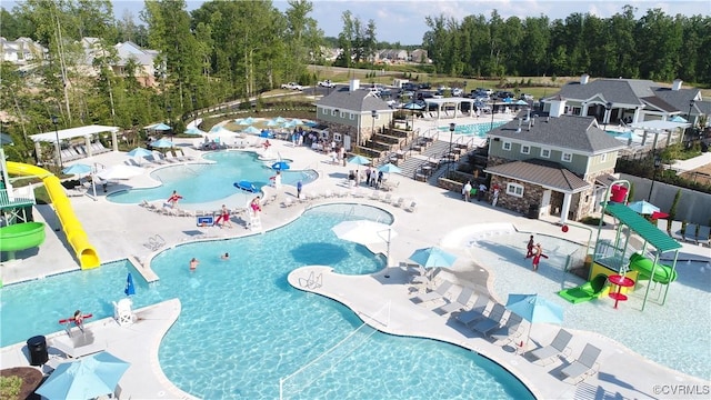 18709 Palisades Cove Trl, Moseley, VA 23120 - community pool featuring a water slide and a patio area