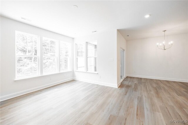 18709 Palisades Cove Trl, Moseley, VA 23120 - empty room with a chandelier and light wood-style flooring