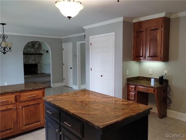3249 N Maidens Rd, Maidens, VA 23139 - kitchen featuring arched walkways, ornamental molding, light tile patterned floors, dark stone countertops, and decorative light fixtures