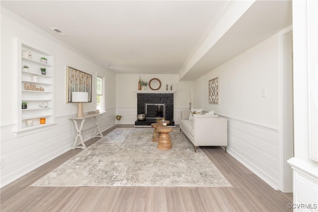 13119 Glenmeadow Ct, Midlothian, VA 23114 - living area with ornamental molding, wood finished floors, a fireplace, built in shelves, and wainscoting