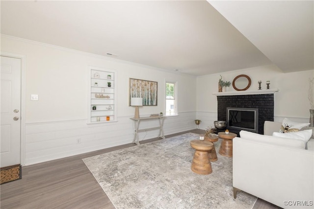 13119 Glenmeadow Ct, Midlothian, VA 23114 - living area featuring wood finished floors, wainscoting, a fireplace, ornamental molding, and built in features