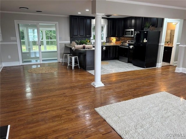 23766 Kings Hwy, Warsaw, VA 22572 - kitchen featuring decorative columns, stainless steel appliances, dark cabinets, ornamental molding, and baseboards