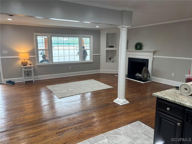 23766 Kings Hwy, Warsaw, VA 22572 - living area featuring decorative columns, ornamental molding, wood finished floors, baseboards, and built in features