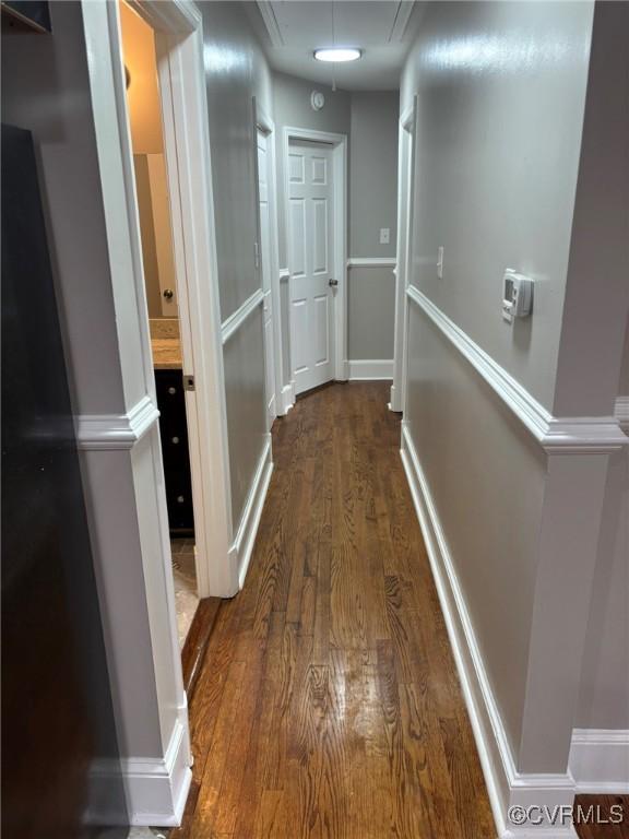 23766 Kings Hwy, Warsaw, VA 22572 - hall with dark wood-style flooring, attic access, and baseboards