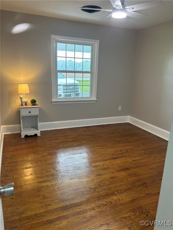 23766 Kings Hwy, Warsaw, VA 22572 - empty room with a ceiling fan, dark wood-style flooring, and baseboards