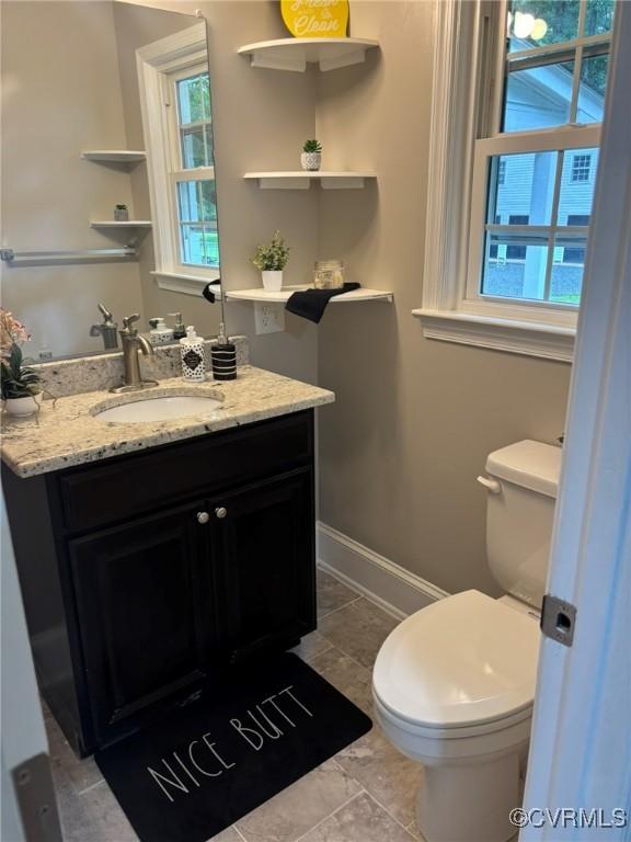23766 Kings Hwy, Warsaw, VA 22572 - half bathroom featuring toilet, vanity, and baseboards