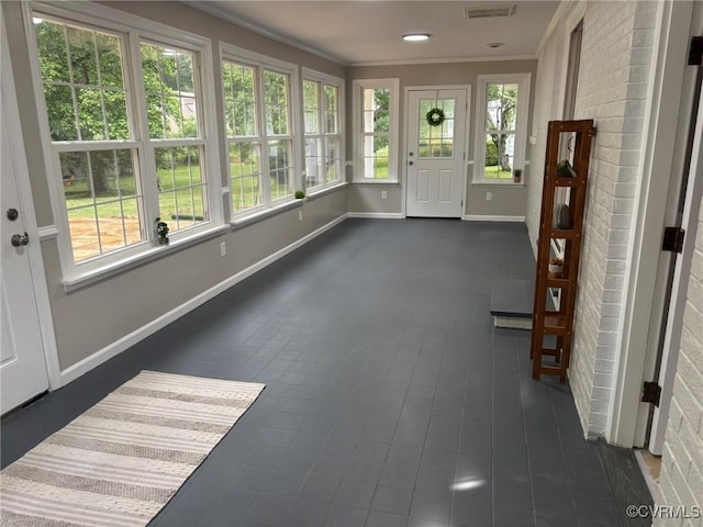 23766 Kings Hwy, Warsaw, VA 22572 - unfurnished sunroom featuring baseboards and crown molding