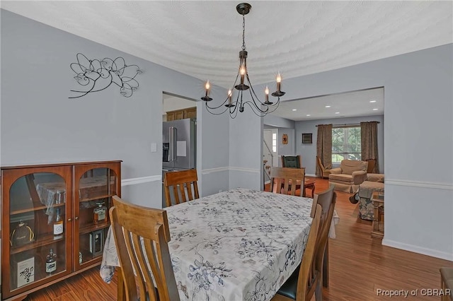 802 Westgate Ct, Newport News, VA 23602 - dining area featuring a chandelier, wood finished floors, and baseboards